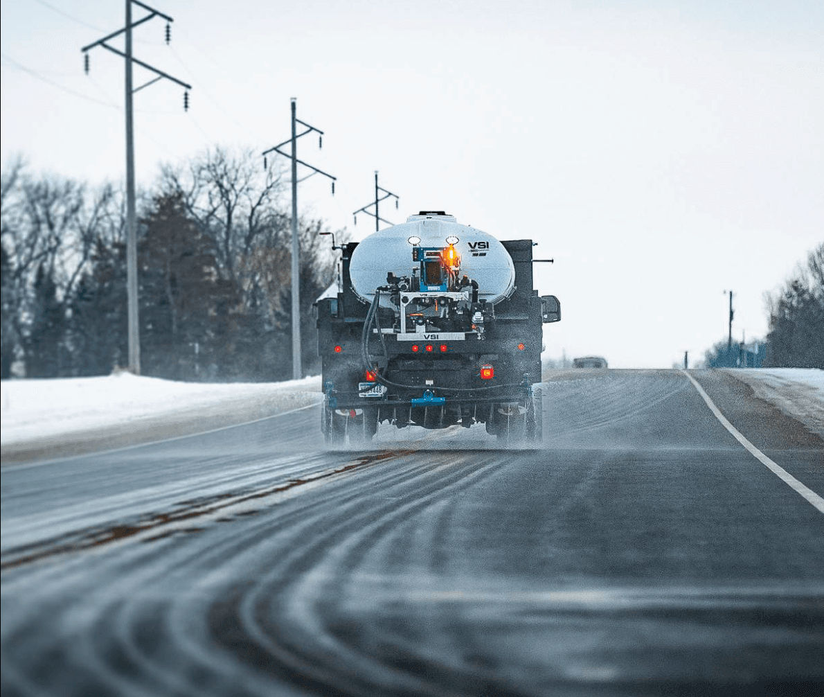 VSI brine truck spreading liquid de-icer on a snowy road